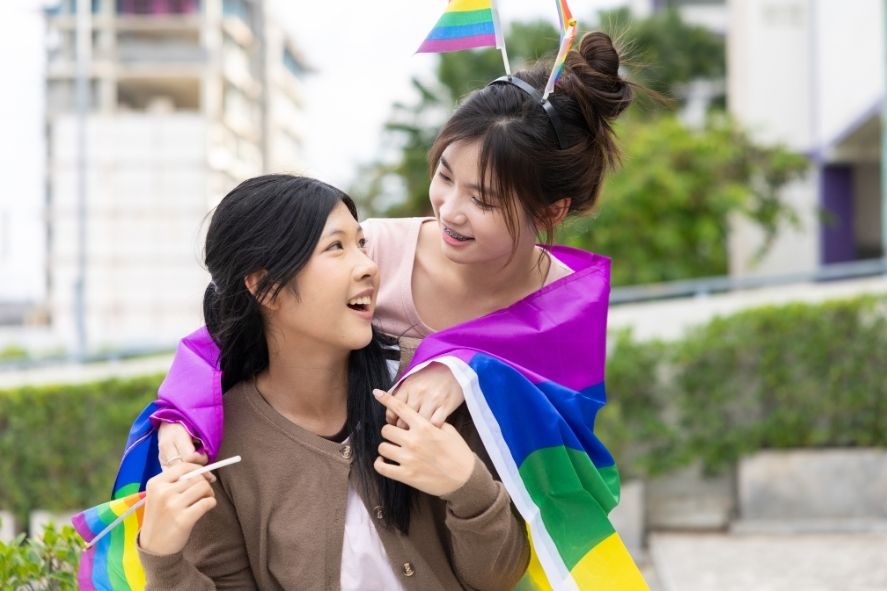 couple celebrating at phuket pride with bright rainbow flags